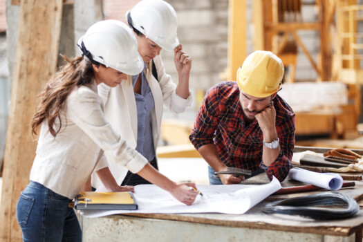 Two,Female,Inspectors,And,Architects,Discuss,With,Head,Engineer,About Two,Female,Inspectors,And,Architects,Discuss,With,Head,Engineer,About